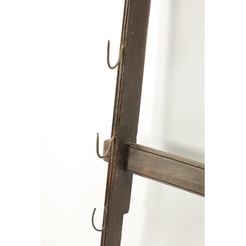 57 - AN 18THN CENTURY OAK WALL HANGING WHIP RACK (154cm high 82cm wide)