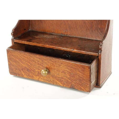 62 - AN 18TH CENTURY WELSH OAK SPOON RACK with frieze drawer and shaped back (57cm high 36cm wide)