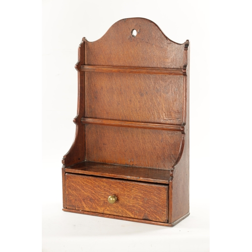 62 - AN 18TH CENTURY WELSH OAK SPOON RACK with frieze drawer and shaped back (57cm high 36cm wide)