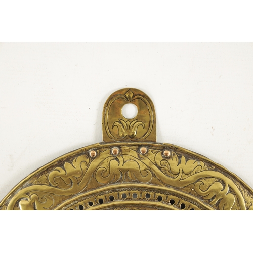 73 - A LATE 17TH CENTURY ADAM & EVE EMBOSSED HANGING WALL LIGHT PLAQUE with scrollwork border (30cm diame... 