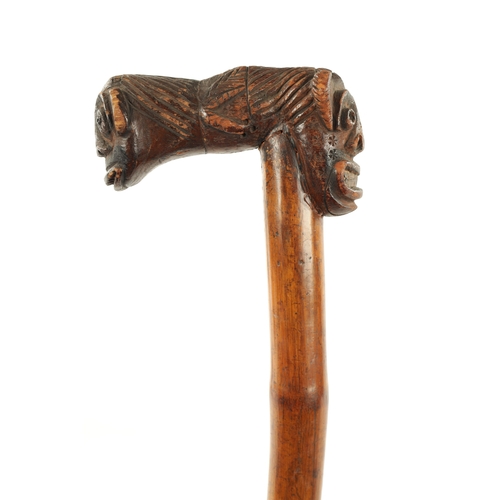 77 - A RARE TWO HEADED GROTESQUE 19TH CENTURY AFRICAN WALKING STICK (89cm overall)