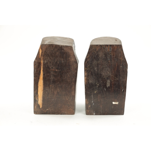 82 - A PAIR OF CARVED HARDWOOD NATIVE BOOKENDS formed as Heads. (22cm high)