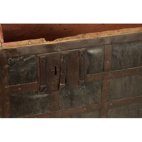 86 - A RARE 17TH CENTURY DOMED TOP IRON BOUND LEATHER COVERED COFFER with side handles and triple lock fr... 