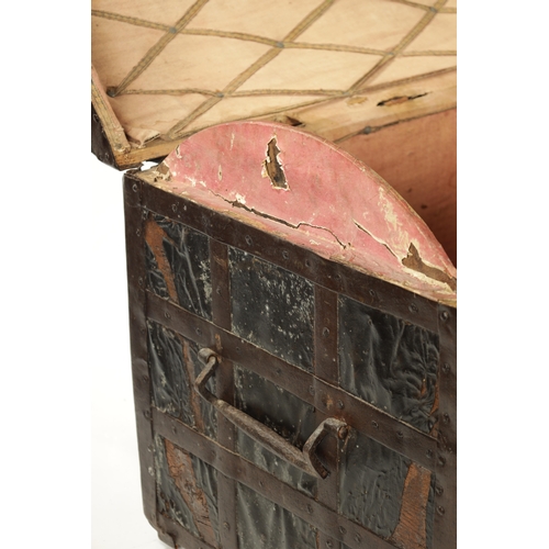 86 - A RARE 17TH CENTURY DOMED TOP IRON BOUND LEATHER COVERED COFFER with side handles and triple lock fr... 