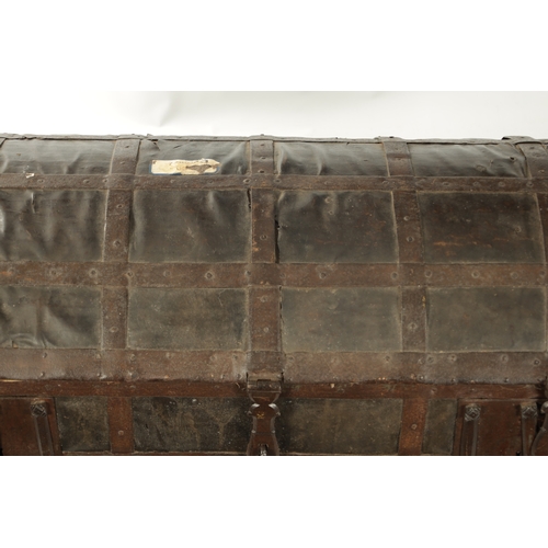 86 - A RARE 17TH CENTURY DOMED TOP IRON BOUND LEATHER COVERED COFFER with side handles and triple lock fr... 