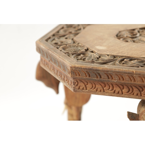 88 - A 19TH CENTURY CARVED HARDWOOD INDIAN OCCASIONAL TABLE raised on elephant's head supports and bone t... 