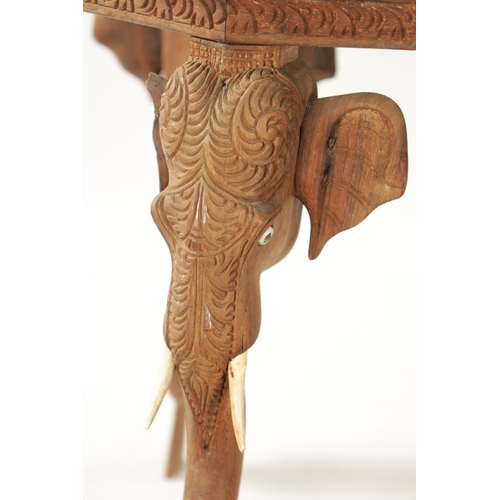 88 - A 19TH CENTURY CARVED HARDWOOD INDIAN OCCASIONAL TABLE raised on elephant's head supports and bone t... 