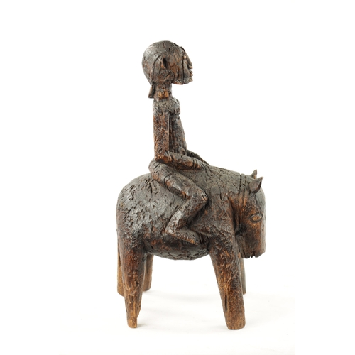 89 - AN ANTIQUE CARVED HARDWOOD AFRICAN FIGURE ON HORSEBACK (24cm wide 44cm high)