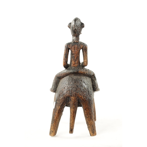 89 - AN ANTIQUE CARVED HARDWOOD AFRICAN FIGURE ON HORSEBACK (24cm wide 44cm high)