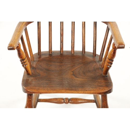 91 - A 19TH CENTURY CHILD'S STICK-BACK WINDSOR CHAIR having elm seat and ring-turned legs (77cm high 47cm... 