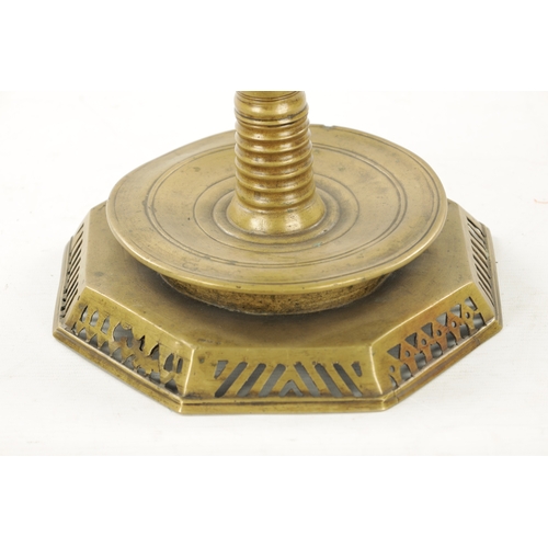 93 - AN UNUSUAL 18TH CENTURY BRASS CANDLESTICK with pierced drip pan and two tier stem (36cm high)