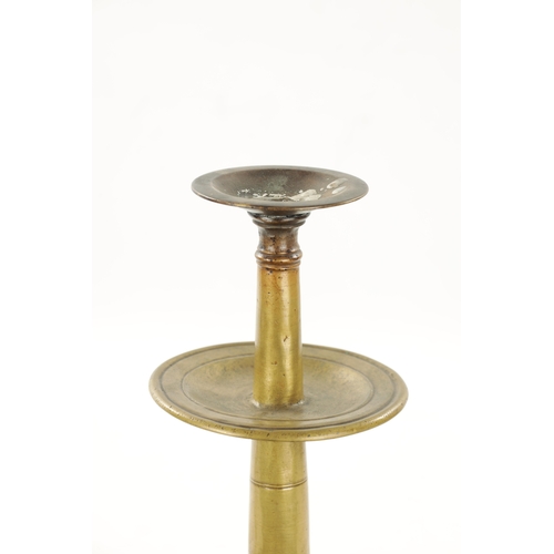 93 - AN UNUSUAL 18TH CENTURY BRASS CANDLESTICK with pierced drip pan and two tier stem (36cm high)