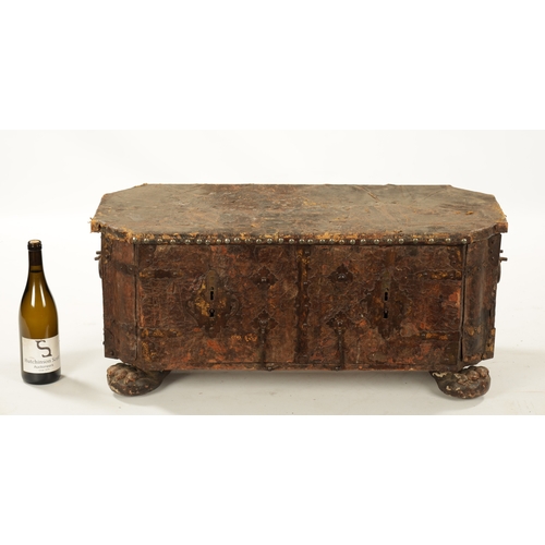 96 - A 17TH CENTURY ITALIAN LEATHER BOUND CASKET with unusual hinged front bearing double locks, side han... 