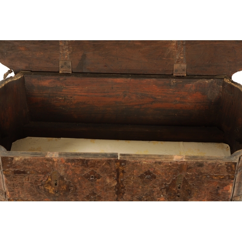 96 - A 17TH CENTURY ITALIAN LEATHER BOUND CASKET with unusual hinged front bearing double locks, side han... 