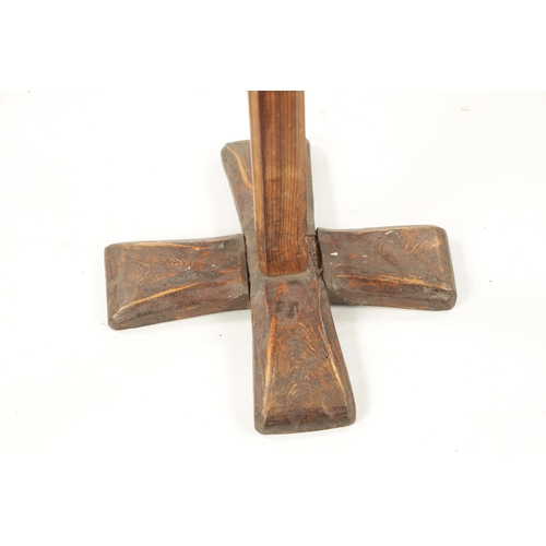 97 - AN 18TH CENTURY PINE AND WROUGHT IRON RUSTIC CANDLESTICK ON STAND with X shaped base (84cm high)