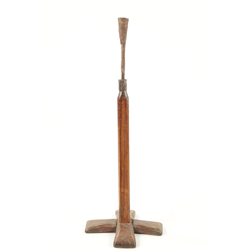 97 - AN 18TH CENTURY PINE AND WROUGHT IRON RUSTIC CANDLESTICK ON STAND with X shaped base (84cm high)