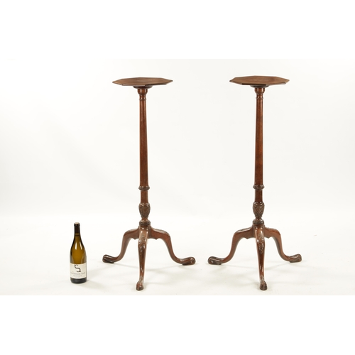 98 - A PAIR OF GEORGE III MAHOGANY CHIPPENDALE STYLE TORCHERES with octagonal tops above leaf carved stem... 