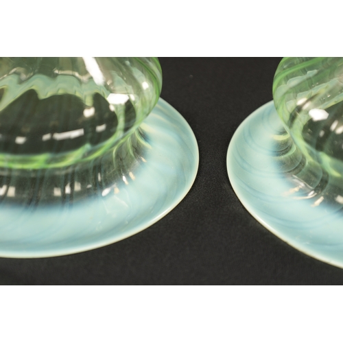 454 - A SET OF THREE 19TH CENTURY VASELINE GLASS SHADES with opalescent rim and twisted bodies (15cm diame... 