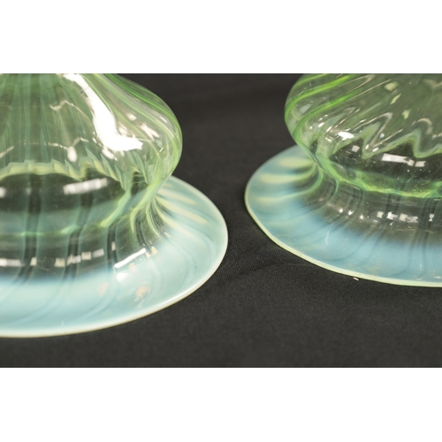 454 - A SET OF THREE 19TH CENTURY VASELINE GLASS SHADES with opalescent rim and twisted bodies (15cm diame... 