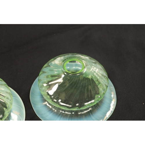 454 - A SET OF THREE 19TH CENTURY VASELINE GLASS SHADES with opalescent rim and twisted bodies (15cm diame... 