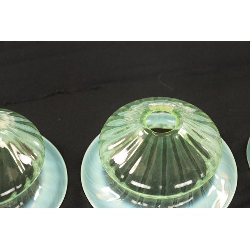 454 - A SET OF THREE 19TH CENTURY VASELINE GLASS SHADES with opalescent rim and twisted bodies (15cm diame... 