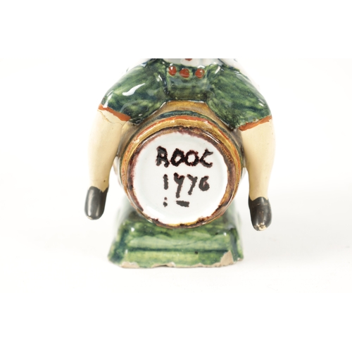 465 - AN 18TH / 19TH CENTURY DELFT POLYCHROME FIGURE modelled as a man sitting on a barrel drinking out of... 