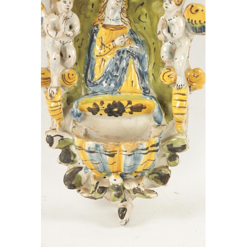 470 - AN EARLY DELFTWARE HANGING HOLY WATER FONT decorated with cherubs surrounding Mary with polychrome c... 