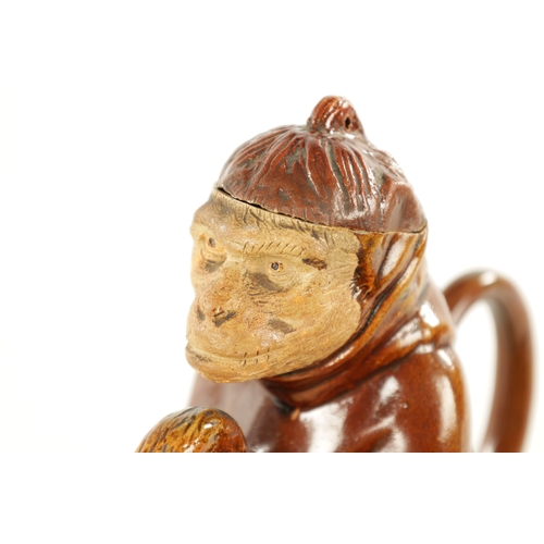 476 - A 19TH CENTURY POTTERY MONKEY PITCHER JUG in the style of Bodlet Vaudancourt, modelled as a clothed ... 