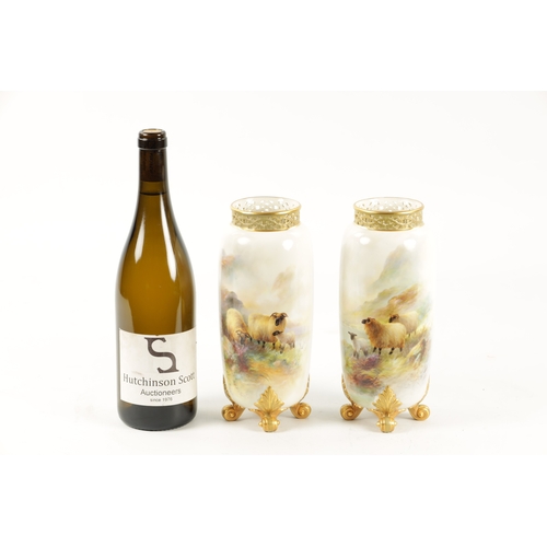 477 - HARRY DAVIS A FINE PAIR OF ROYAL WORCESTER CABINET VASES the cylindrical bodies finely painted with ... 