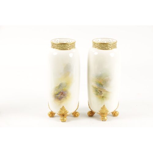 477 - HARRY DAVIS A FINE PAIR OF ROYAL WORCESTER CABINET VASES the cylindrical bodies finely painted with ... 