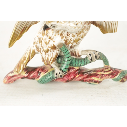 480 - A 19TH CENTURY MAJOLICA TYPE CERAMIC WALL PLAQUE modelled as an eagle and serpent perched on branchw... 