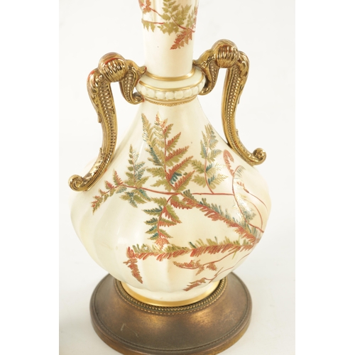 482 - AN EARLY 20TH CENTURY BLUSH ROYAL WORCESTER TABLE LAMP decorated with gilt highlighted leafwork (62c... 