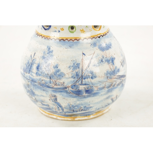 484 - AN 18TH CENTURY DUTCH DELFTWARE PUZZLE JUG with polychrome decoration and blue and white landscape s... 