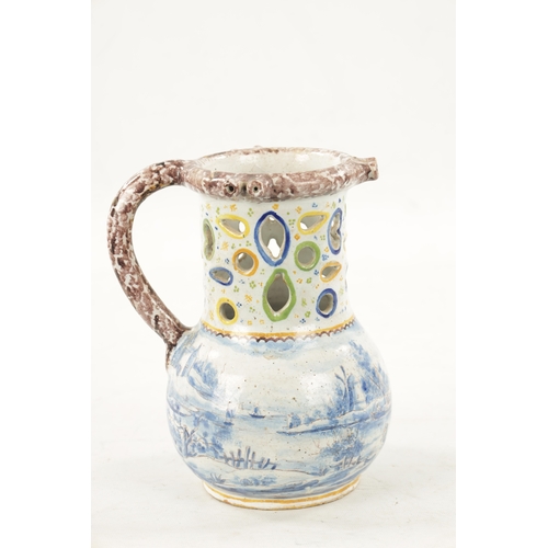 484 - AN 18TH CENTURY DUTCH DELFTWARE PUZZLE JUG with polychrome decoration and blue and white landscape s... 