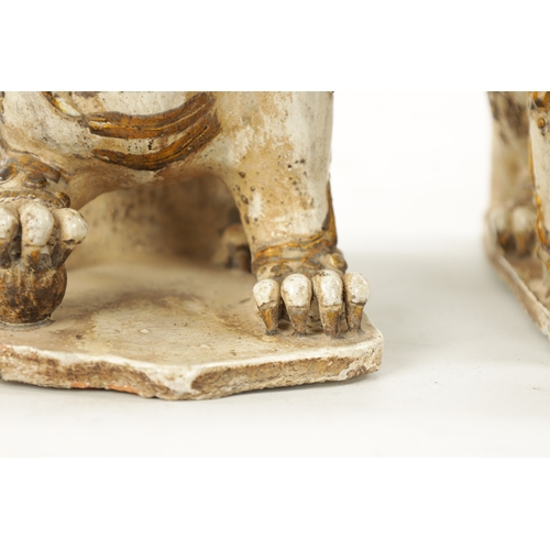 495 - A PAIR OF 19TH CENTURY CHINESE CERAMIC FOO DOGS with gilt highlights (22cm high 23cm wide )