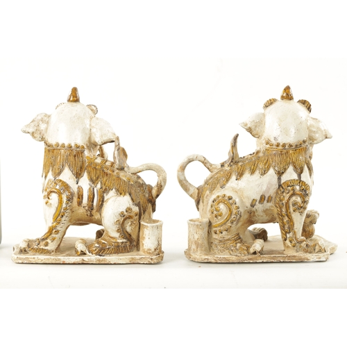 495 - A PAIR OF 19TH CENTURY CHINESE CERAMIC FOO DOGS with gilt highlights (22cm high 23cm wide )