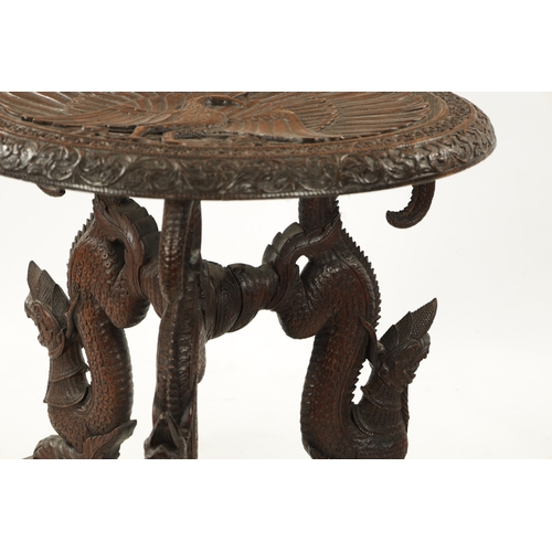 496 - A 19TH CENTURY INDIAN HARDWOOD OCCASIONAL TABLE the circular top with carved scrollwork border enclo... 