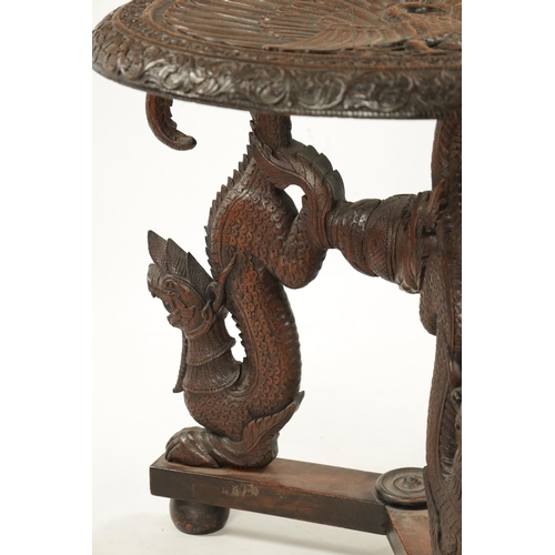 496 - A 19TH CENTURY INDIAN HARDWOOD OCCASIONAL TABLE the circular top with carved scrollwork border enclo... 