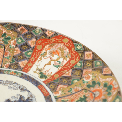 523 - A PAIR OF 19TH CENTURY JAPANESE IMARI CHARGERS decorated with brightly coloured leaf work panels (45... 