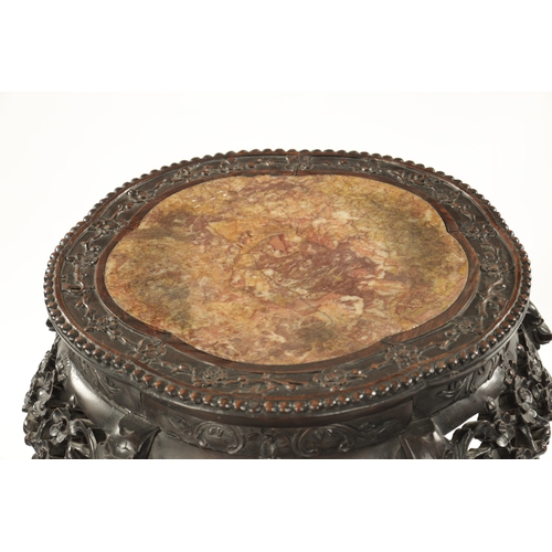 529 - A 19TH CENTURY CHINESE CARVED HARDWOOD JARDINIERE STAND the shaped top with carved border enclosing ... 