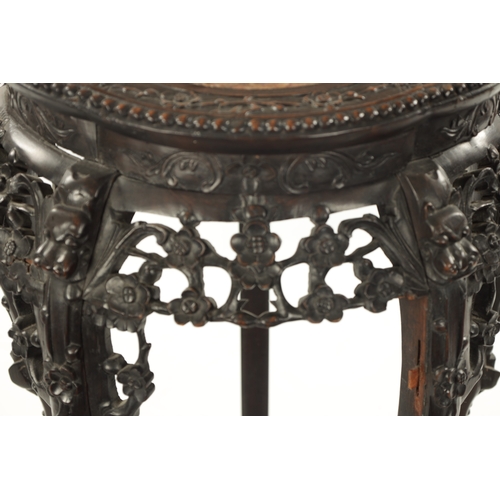 529 - A 19TH CENTURY CHINESE CARVED HARDWOOD JARDINIERE STAND the shaped top with carved border enclosing ... 