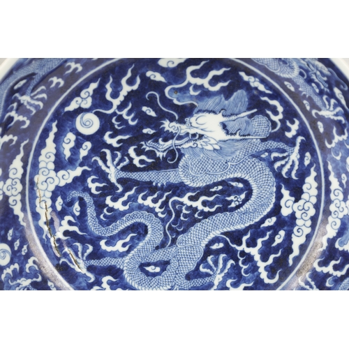 531 - A CHINESE BLUE AND WHITE PORCELAIN DRAGON BOWL with five-claw entwined dragon amongst clouds. (25.5c... 