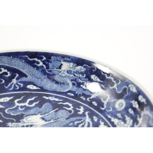 531 - A CHINESE BLUE AND WHITE PORCELAIN DRAGON BOWL with five-claw entwined dragon amongst clouds. (25.5c... 