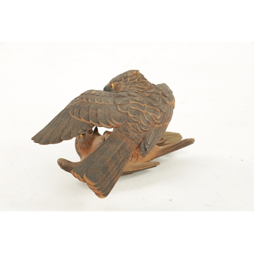 532 - A JAPANESE MEIJI PERIOD CARVED WOOD OKIMONO OF TWO QUARRELLING HAWKS both with fine engraved feather... 