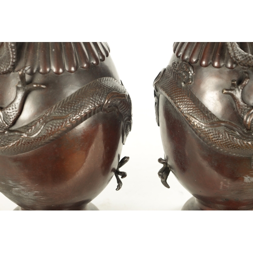 537 - A PAIR OF TWO LATE 19TH CENTURY CHINESE BRONZE VASES with entwined dragon decoration (42.5cm high)