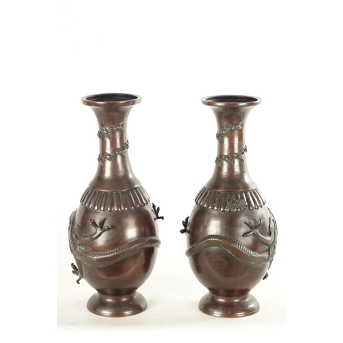 537 - A PAIR OF TWO LATE 19TH CENTURY CHINESE BRONZE VASES with entwined dragon decoration (42.5cm high)