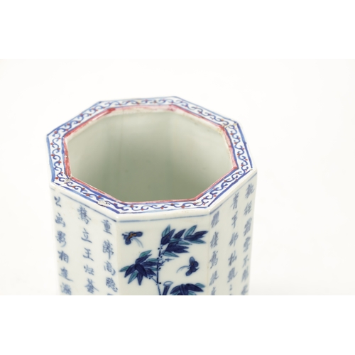 545 - A CHINESE QING DYNASTY BLUE AND WHITE OCTAGONAL SHAPED BRUSH POT with script and blossoming trees to... 