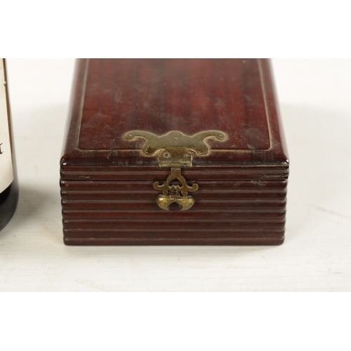 547 - A CHINESE HARDWOOD DRESSING TABLE BOX with hinged mirrored lid, reeded sides and shaped brass catch ... 