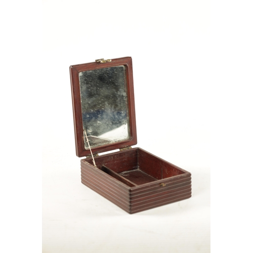 547 - A CHINESE HARDWOOD DRESSING TABLE BOX with hinged mirrored lid, reeded sides and shaped brass catch ... 