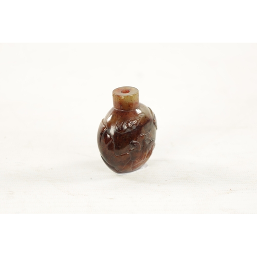 551 - A CHINESE CARVED RUSSET JADE SNUFF BOTTLE carved with an immortal and monkey, deer and bat to revers... 